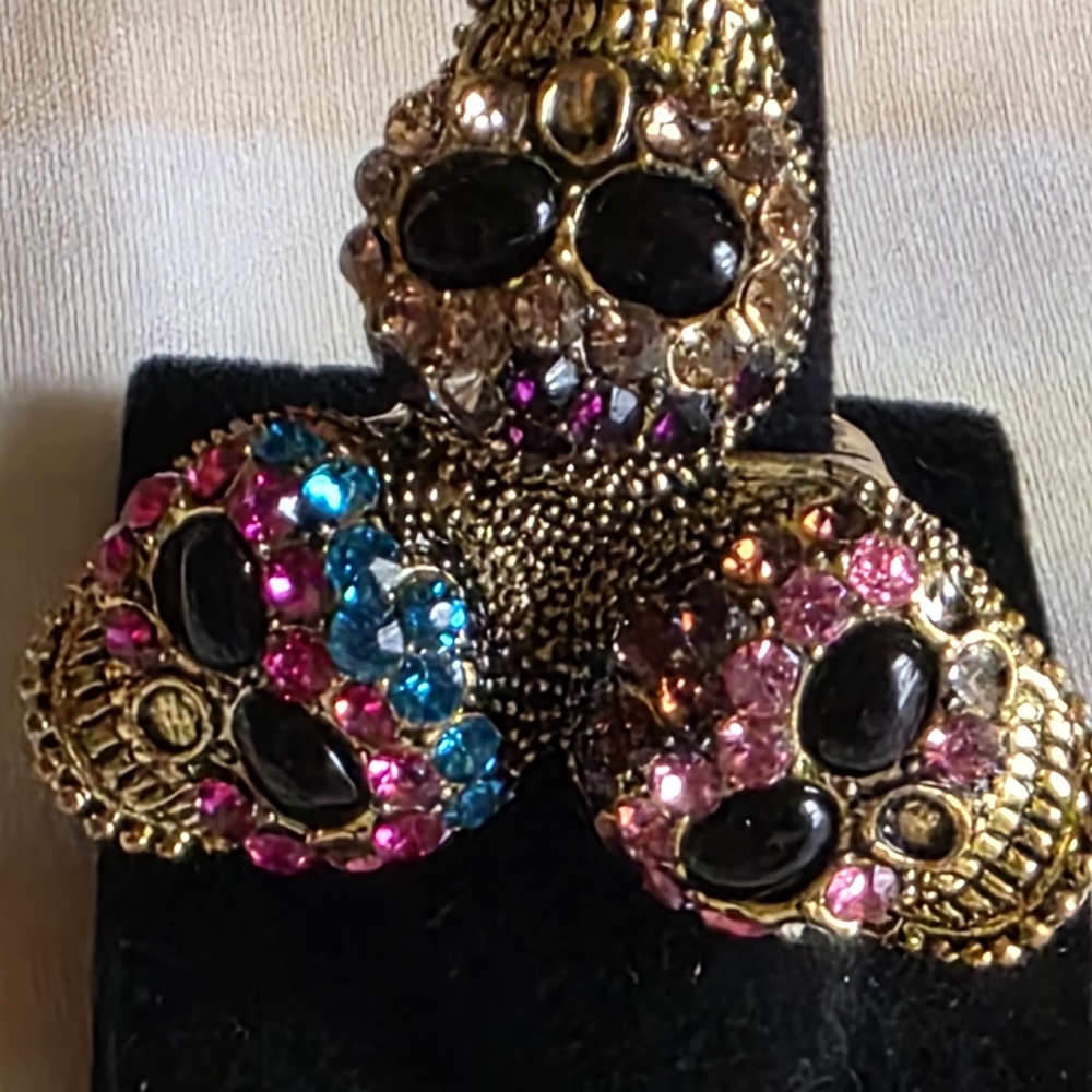 Glamorous Gold Skull Ring with Black, Pink, and Blue Crystals